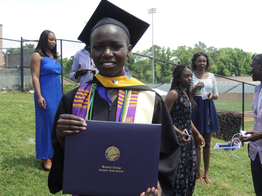 Image of a girl graduating from college with a diploma.